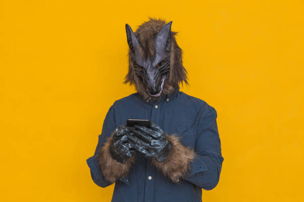 A werewolf using a cell phone stock photo