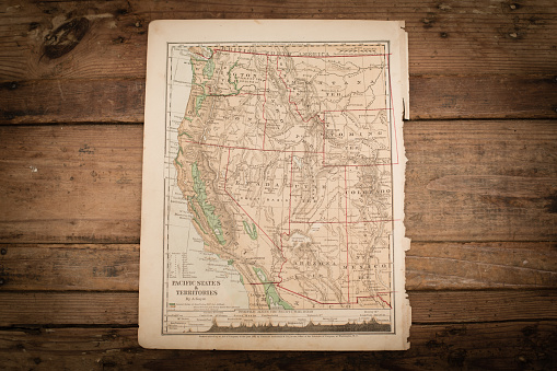 Color stock photo of an antique Western United States map illustration page on an old, wooden trunk. Salvaged from an 1871 geography book.