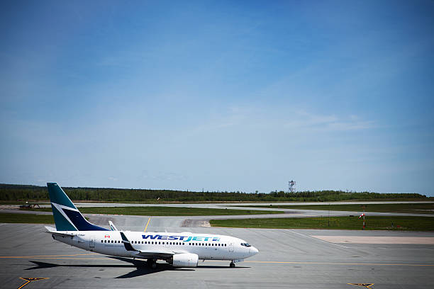 WestJet Flight taking off from Stanfield International Airport. stock photo