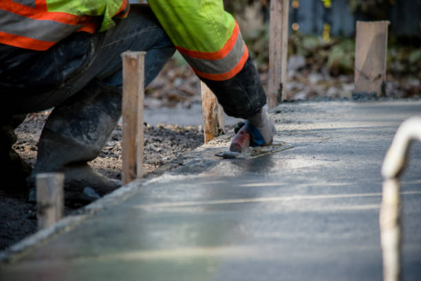wet cement Smoothing wet cement with a building contractor photos stock pictures, royalty-free photos & images