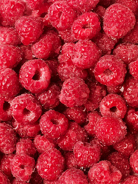 Wet raspberries background stock photo