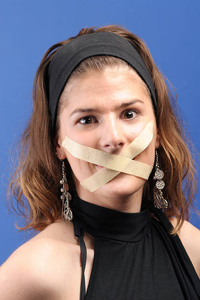 What the..... Woman with taped mouth. human mouth gag adhesive tape women stock pictures, royalty-free photos & images