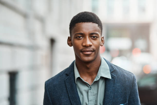 What you bring determines what you become Portrait of a confident young businessman standing against an urban background blank expression photos stock pictures, royalty-free photos & images