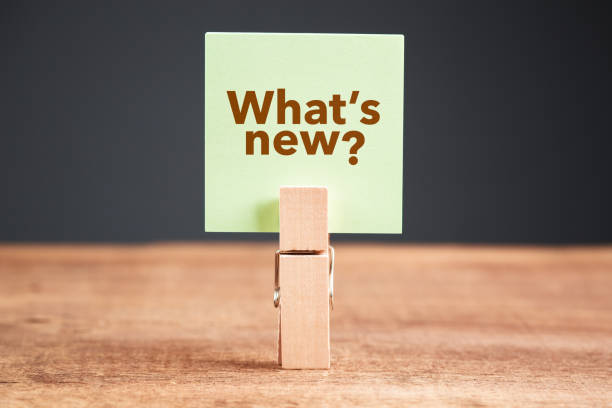 What's New? Green paper with text : What's New?, clip on wood clothespin new stock pictures, royalty-free photos & images