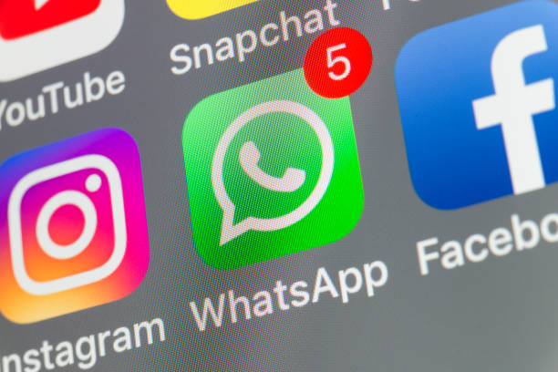 WhatsApp, Facebook, Instagram and other cellphone Apps on iPhone screen London, UK - August 02, 2018: The buttons of WhatsApp, Facebook, Instagram, Snapchat and Youtube on the screen of an iPhone. whatsapp stock pictures, royalty-free photos & images