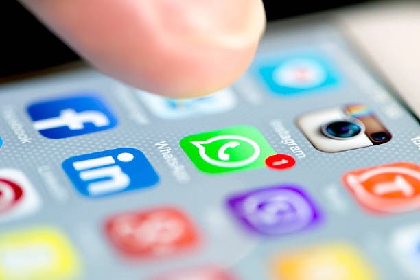 Whatsapp with One Notification While a Finger Taps to Open Istanbul, Turkey - September 18, 2015: Apple Iphone 6 screen with social media applications of Whatsapp, Facebook, Instagram, Viber, Linkedin, Tango, Perisfind and Snapchat while a male finger is about to touch on Whatsapp app. whatsapp stock pictures, royalty-free photos & images