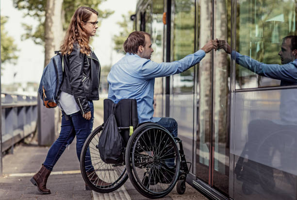 wheelchair using young man and his girlfriend travelling around a modern city - wheelchair street imagens e fotografias de stock