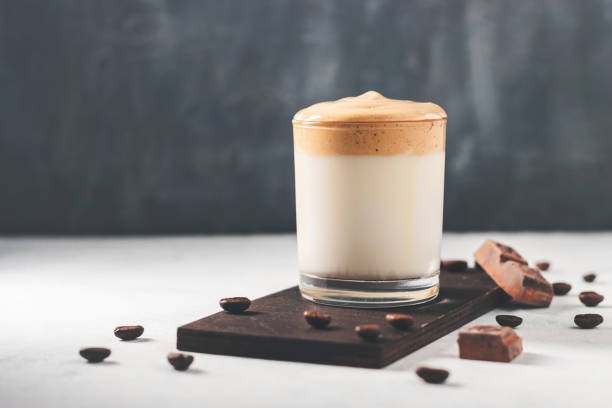 whipped dalgona coffee drink in a glass with milk, dark background - milk foam of a cappuccino 個照片及圖片檔