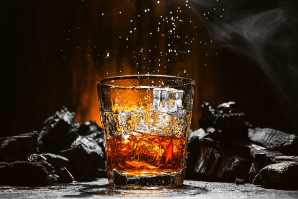 whiskey is poured into a glass stock photo