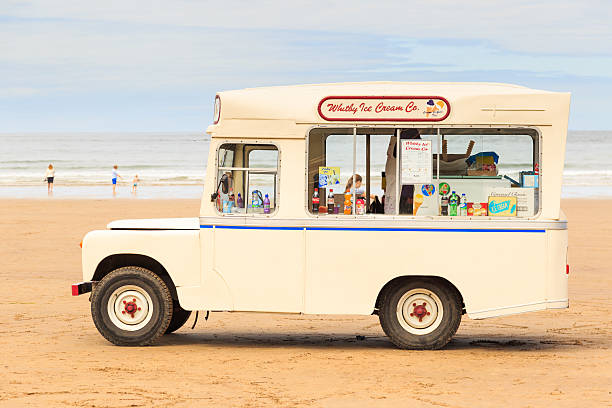 'Whitby Ice Cream Co' ice cream van on beach, Whitby Whitby, England - July 12, 2016: A 'Whitby Ice Cream Co' ice cream van on the beach. In Whitby, North Yorkshire, England. ice cream truck stock pictures, royalty-free photos & images