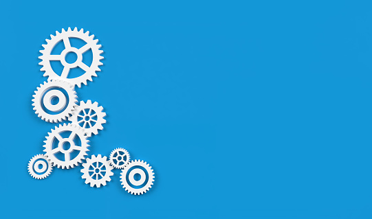 White gears or cogwheels on blue background for industry mechanic or technology 3D rendering