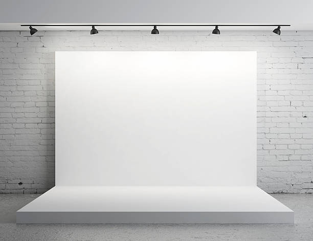 A white backdrop with stage lights White backdrop in room with grey paint on wall backdrop artificial scene stock pictures, royalty-free photos & images
