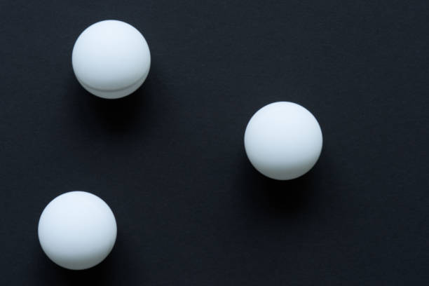 White ball on black background Three white balls scattering on black surface cue ball stock pictures, royalty-free photos & images