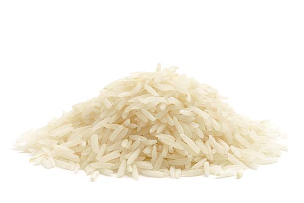 White basmati rice Basmati rice in a heap isolated on a white background. white rice stock pictures, royalty-free photos & images