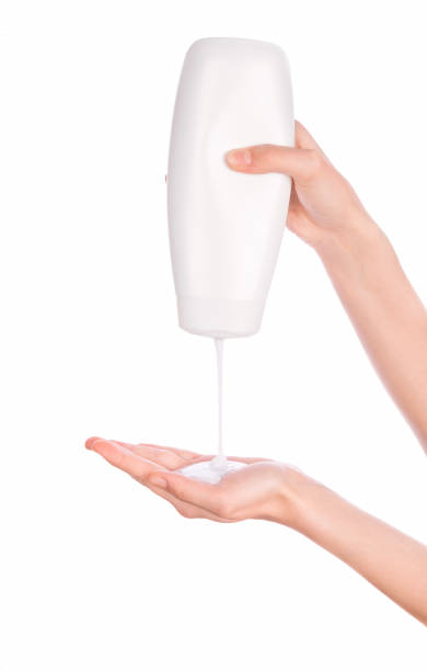 White bottle of shower gel lotion cream in hands stock photo