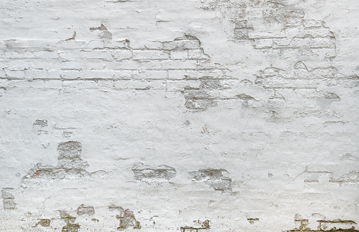 White brick wall background. Weathered plaster texture