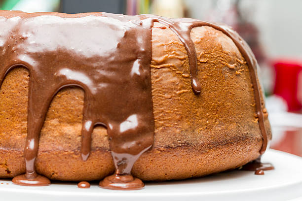 White cake with melted chocolate syrup on top stock photo