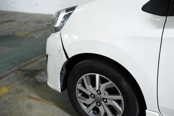 a white car with a damaged bumper in the parking lot. - black car scratch imagens e fotografias de stock
