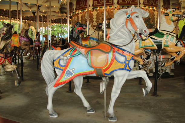 White Carousel Horse with Multicolored Saddle White carousel horse with multicolored saddle carousel horses stock pictures, royalty-free photos & images
