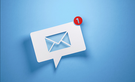 White chat bubble with email symbol on blue background. Horizontal composition with copy space.