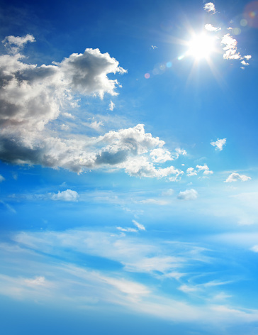 conceptual cloudscape image with blue sky and sunbeam