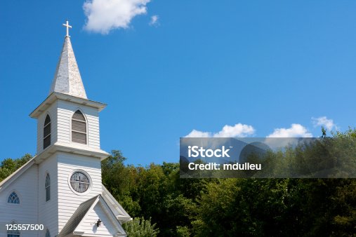 istock White community church against blue sky 125557500