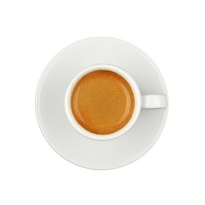 Close up one white cup full  of espresso coffee, on saucer, isolated on white background, elevated top view, directly above