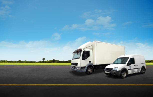 White Delivery Van and Truck on the Road stock photo