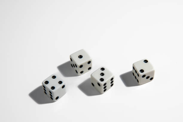 White dice with a one, two, three and four standing close to each other on a white background. Win or lose. Catch your luck. Gambling equipment. stock photo