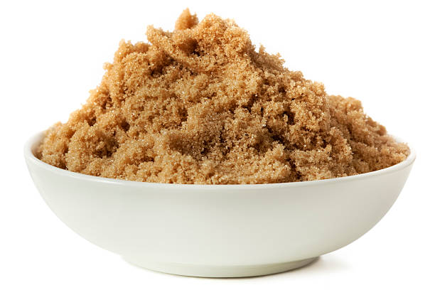 White dish of brown sugar on white background stock photo