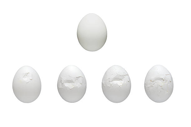 white egg crushing process stock photo
