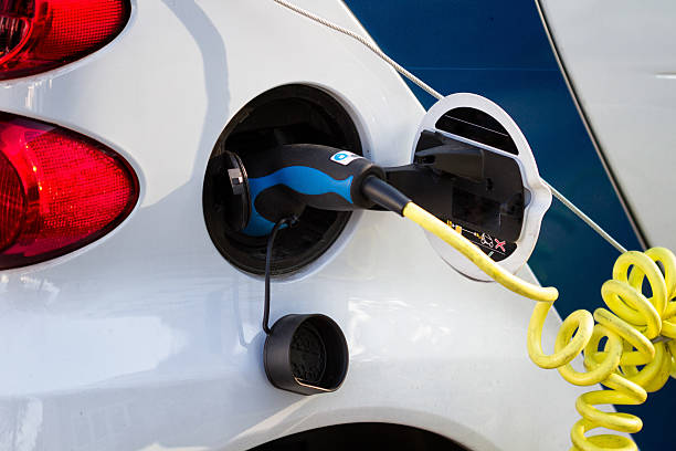 white electric car during refueling stock photo