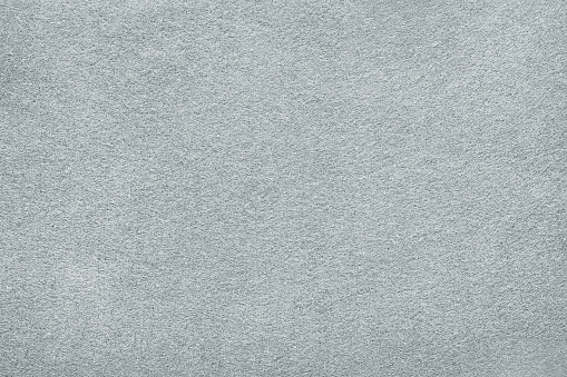 White or light gray felt background. Carpet, table surface or fabric texture