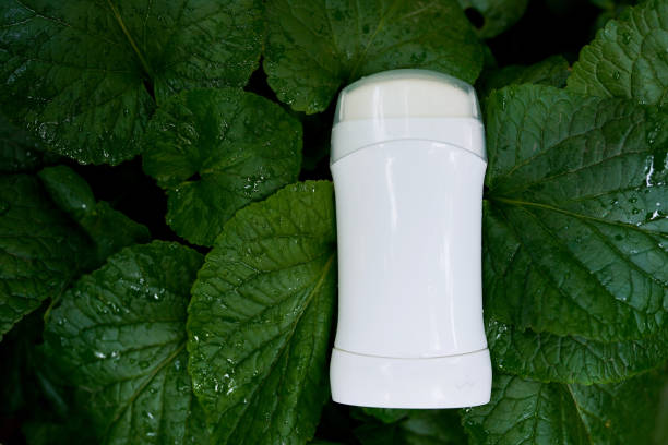 white female deodorant on nature green background white female deodorant on nature green background deodorant stock pictures, royalty-free photos & images