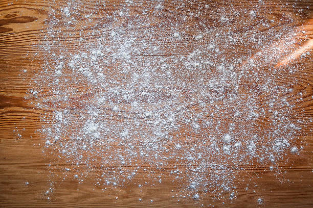 White flour scattered on rustic wooden board, Baking background stock photo