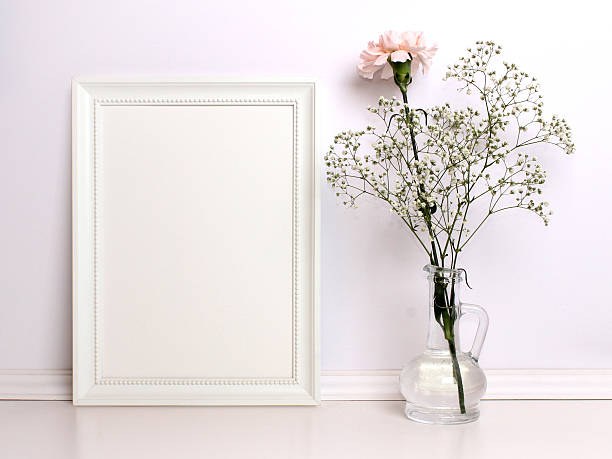 White frame mockup with flowers. White frame mockup with flowers. Poster product design styled mock-up. table photos stock pictures, royalty-free photos & images