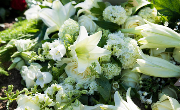 white funeral flowers stock photo