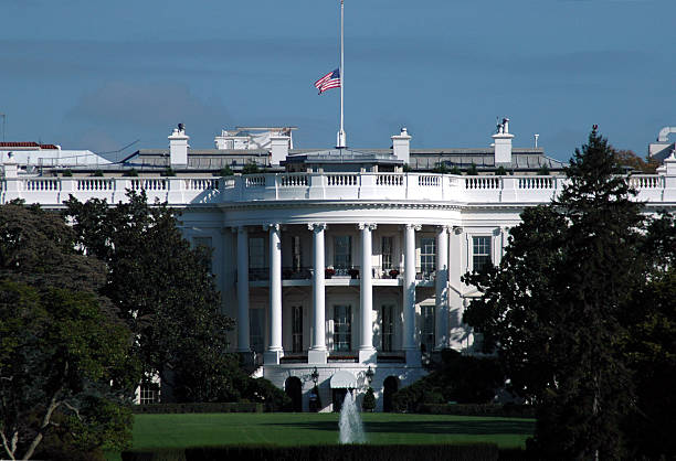 White House in Mourning White House in Washington, D.C.  Flag at half-mast. flag at half staff stock pictures, royalty-free photos & images