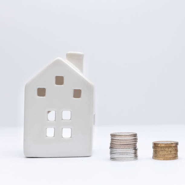 White house with coins as a concept of investment in property. stock photo
