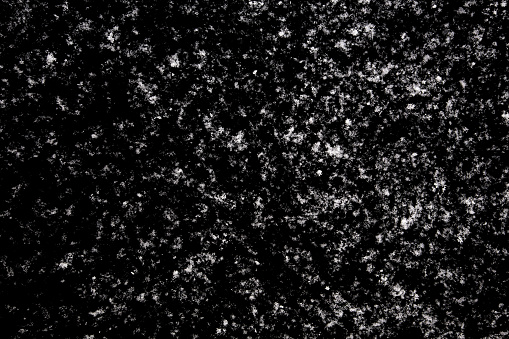 white icy snowflakes isolated on black background, natural background