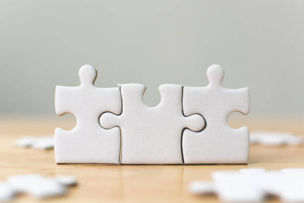 White jigsaw puzzle connecting together. Team business success partnership or teamwork concept White jigsaw puzzle connecting together. Team business success partnership or teamwork concept relationship stock pictures, royalty-free photos & images
