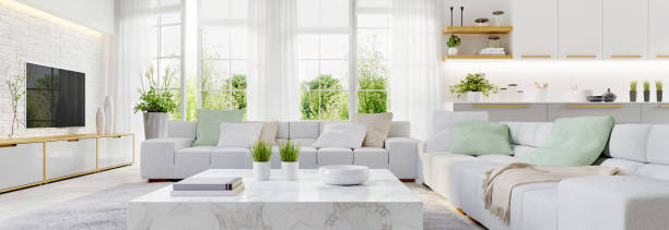 White kitchen and modern living room with large windows stock photo
