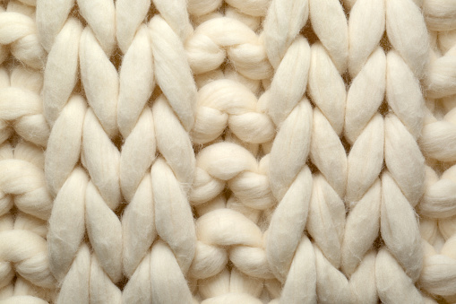 White knitted wool texture as background, top view