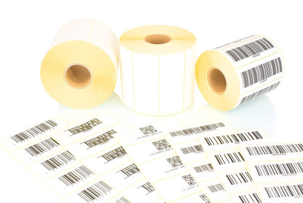 White label rolls and printed barcodes isolated on white background with shadow reflection. White reels of labels for printers. Labels for direct thermal or thermal transfer printing. Barcode samples. White label rolls and printed barcodes isolated on white background with shadow reflection. White reels of labels for printers. Labels for direct thermal or thermal transfer printing. Barcode samples. labeling stock pictures, royalty-free photos & images