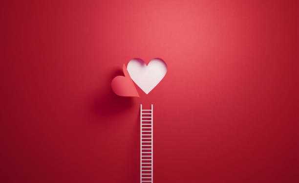 scala bianca appoggiata alla parete rossa con forma a cuore ritagliato - amore foto e immagini stock