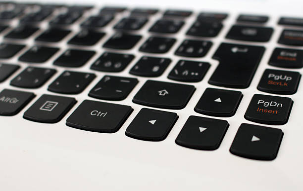 White laptop keyboard with black arrow buttons stock photo