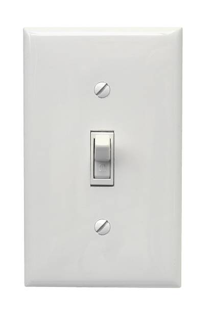 White light switch in the on position a white light switch with cover plate on a white background light switch stock pictures, royalty-free photos & images