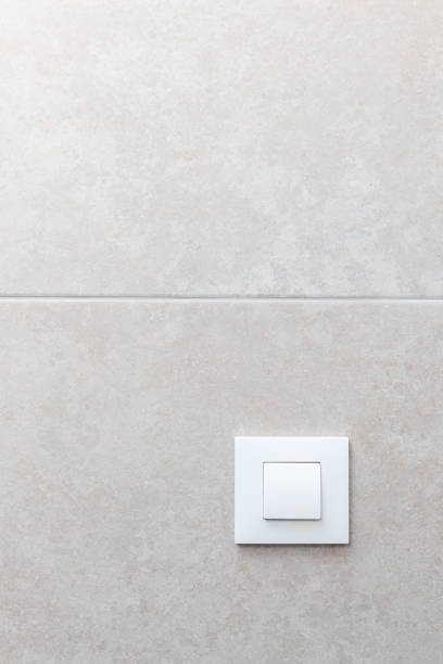 White Light Switch on Grey Tiles stock photo
