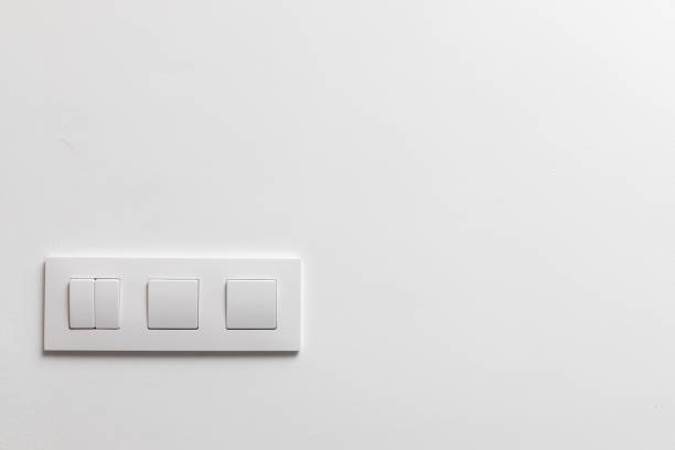 White Light Switches on White Wall stock photo