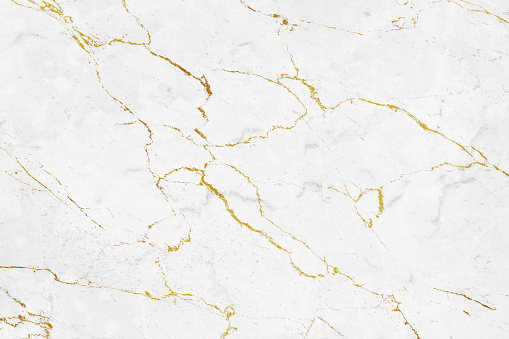 Closeup photo background of natural marble pattern. White marble stone texture with golden veins, front view